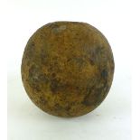 An 18th century cast mortar cannonball, with hollowed centre, dia.