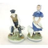 A Royal Copenhagen ceramic figure modeled as a farmhand with two sheep marked to base No.