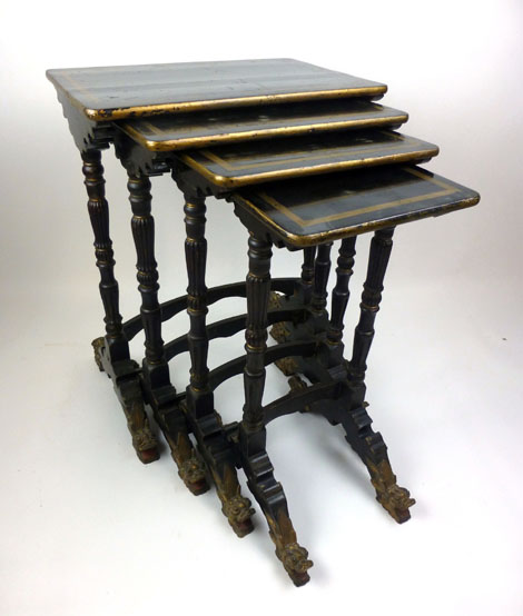 A 19th century Chinese black lacquered and parcel gilt quartetto nest of tables on turned reeded