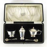 A cased set of tabletop silver hallmarked condiments to include pepper pot, salt and two spoons,