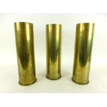 Two 105 MM M14 Type I brass shell cases marked 1943, together with a Type II shell case,