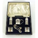 A cased set of nine silver hallmarked table condiments, Birmingham 1923, weight approx.