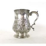 A silver hallmarked tankard with a single scroll engraved handle,