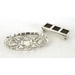 A silver hallmarked desktop stamp holder together with a silver hall marked embossed pin dish,