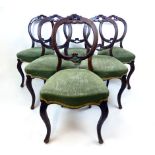 A set of six Edwardian walnut balloon back dining chairs upholstered in green cut fabric on