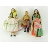 Three fabric and plastic national dolls