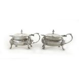 A pair of silver hallmarked mustard pots with blue glass liners, London 1916, weight approx.