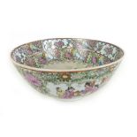 A 19th century Chinese famille verte bowl decorated with a group of figures, with a floral border,