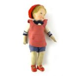 An early 20th century fabric stuffed doll with composite head, modeled as a young boy,