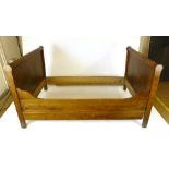 A French oak and elm single bed. h. 100 cm, w. 110 cm, l.