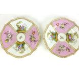 A pair of Dresden cabinet plates, decorated with lovers on a pink ground with gilt scroll borders,