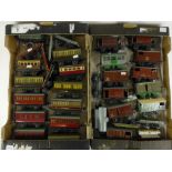 A collection of Hornby O gauge tinplate rolling stock including various coaches, wagons,