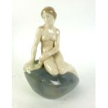 A Royal Copenhagen ceramic figure modeled after 'The Little Mermaid' seated on a rock inscribed