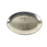 A stainless steel tray of ovoid form embossed with mounted eagle and swastika,