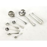 A collection of eight silver items to include ladles, sugar tongs, salts, spoons etc.