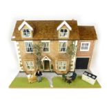 A large hand made dolls house in the form of modern detached house with garage, large front garden,