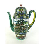 A salt glazed oriental tea pot depicting river and floral scene with a dragon decorated handle,