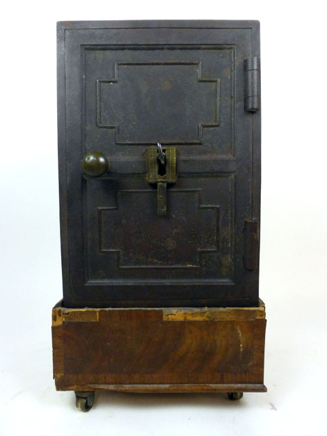 A 19th century cast iron safe on associated wooden base with hidden lock feature, safe h. 51 cm, w.