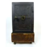 A 19th century cast iron safe on associated wooden base with hidden lock feature, safe h. 51 cm, w.