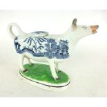 A 19th century Staffordshire-style cow creamer, with blue and white oriental patterned body, h.