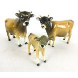 A trio of Beswick Jersey cows including a bull, cow and calf, all with two tone glossed finish, max.