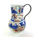 A late 18th century Chinese jug, with blue and red village scene decoration, and a later handle, h.