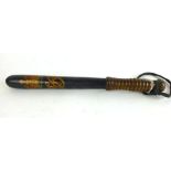 A Victorian hand painted and turned oak police truncheon with the royal cipher emblem to the top