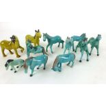 A collection of blue Chinese Tang-type figures modelled as horses together with two yellow