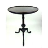 A Georgian mahogany wine table the dish top on turned and gadrooned column on three legs. h.