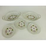 A collection of eleven ceramic lattice pierced plates with printed floral decoration with green and