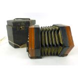 A late 19th century Lachenal mahogany ended twenty button squeeze box concertina,
