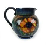 A mid-20th century Moorcroft jug, decorated in a floral pattern, h.