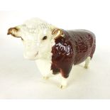 A Beswick ceramic figure modeled as a Hereford bull, with brown and white finish gloss, h.