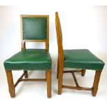 A set of six early 20th century oak Arts & Crafts dining chairs in green leatherette upholstery on