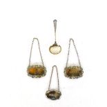 Three silver hallmarked spirit labels together with a silver hallmarked tea straining spoon,