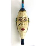 A 20th century carved and brightly painted Nubian wall hanging face mask