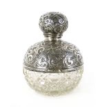 An early 20th century silver topped and glass perfume bottle CONDITION REPORT: