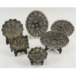 PERSIAN SILVER HAND MIRRORS, a collection of six similar with repousse decorated backs,