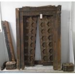 ASIAN DOOR, carved and studded detail with a decorative door surround, approx 221cm x 165cm.