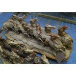 HORSE CARVING, petrified wood of nine horses carved from a fossilized tree trunk, 98cm L.