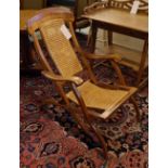 STEAMER CHAIR, late 19th/early 20th century beech with caned seat and back panel, folding action.