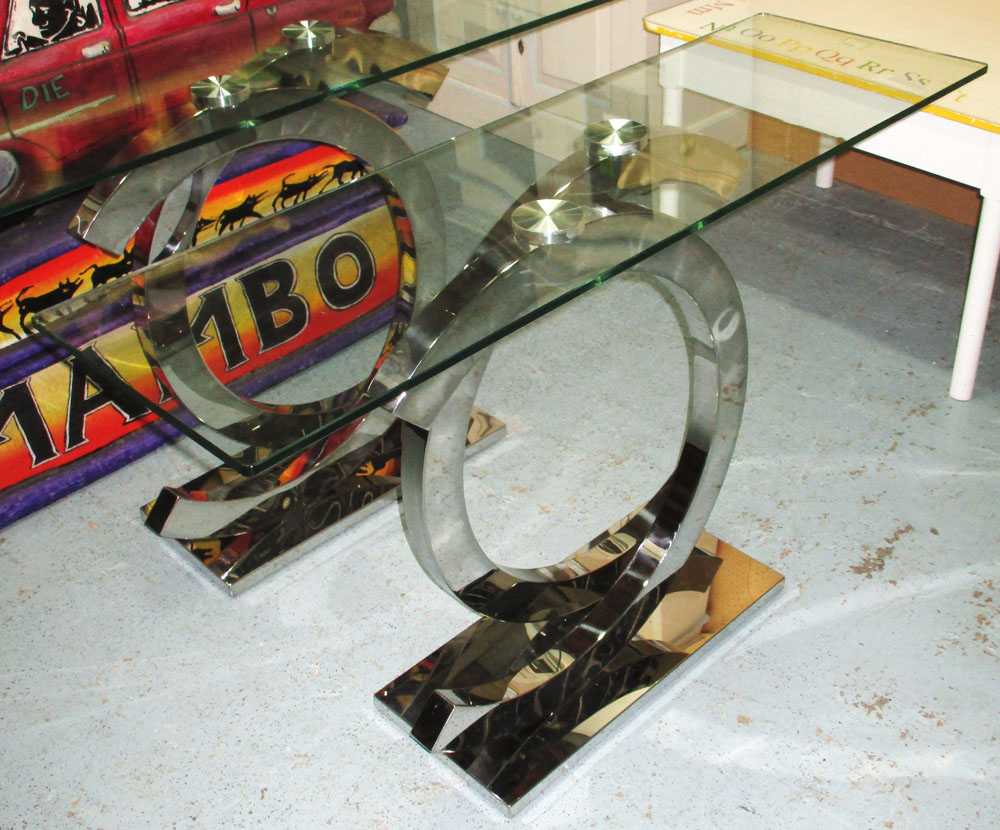 'COCO' CONSOLE TABLE, with glass top on a chromed metal base, 121cm x 38cm x 78cm H.