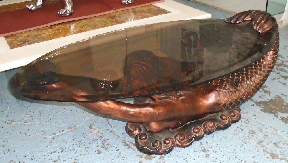 MERMAID LOW TABLE, having a bevelled edge smoked glass top raised on a mermaid figured base,