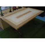 DINING TABLE, the specimen travertine top in a geometric design on curved metal base,