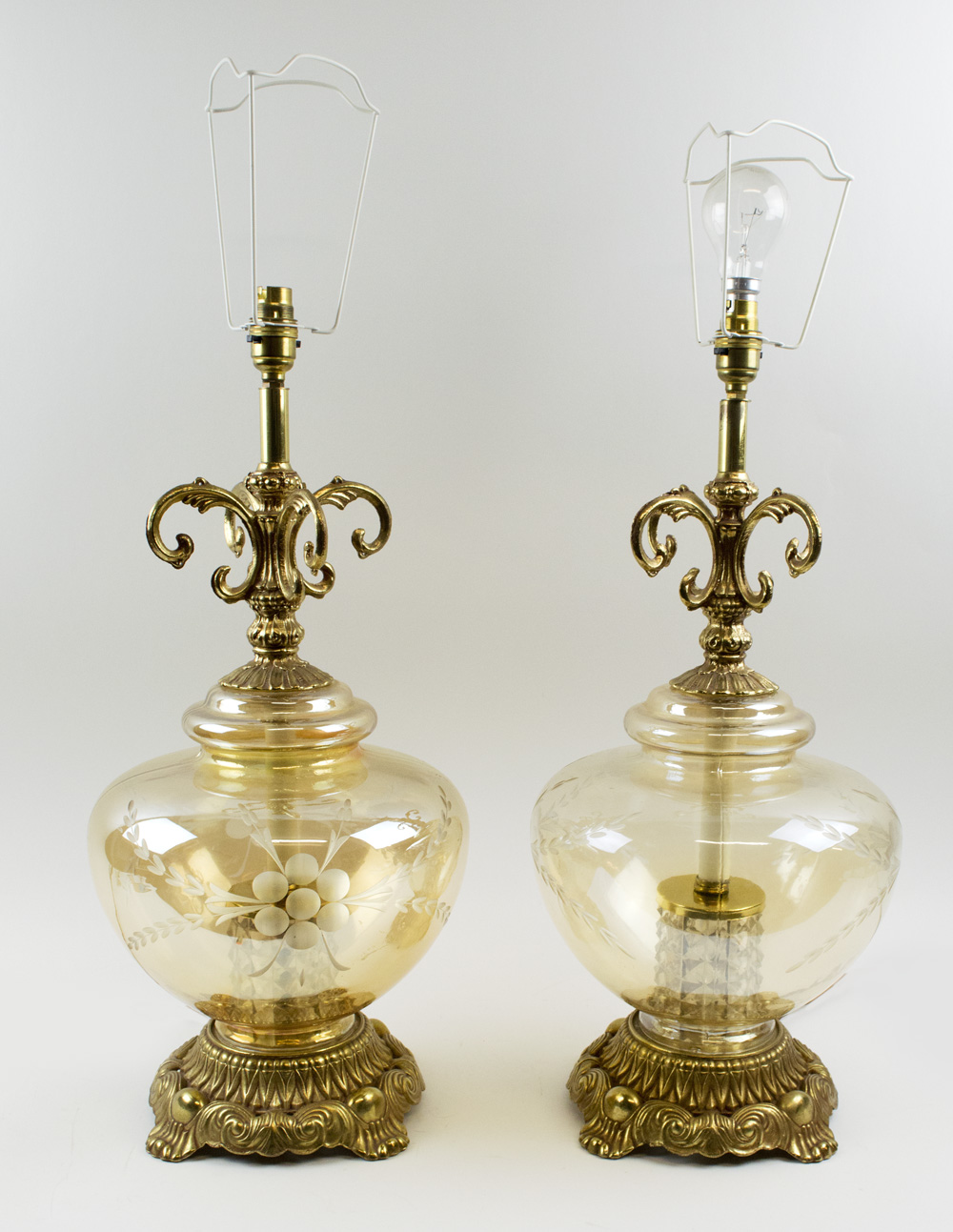 TABLE LAMPS, a pair, amber tinted glass, with foliate cast gilt metal mounts, 52cm H.