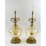 TABLE LAMPS, a pair, amber tinted glass, with foliate cast gilt metal mounts, 52cm H.