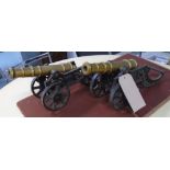 CANNONS, a pair, in brass, on carriages, 43cm L.