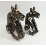 LAUGHING DOGS, two similar, West African painted and carved wooden studies, 42.5cm H and 37cm H.