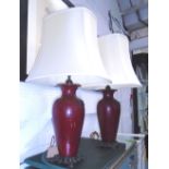 LAMPS, a pair, burgandy urn shaped bases with gilt detail, with shades, each 78cm H overall.