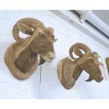 RAMS HEADS, a pair, in carved wood, 31cm H.